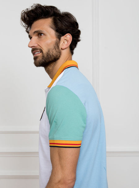 Man wearing multicoloured polo shirt with newmarket 875 crest on the front and number 7 on the back, made of 100% cotton.